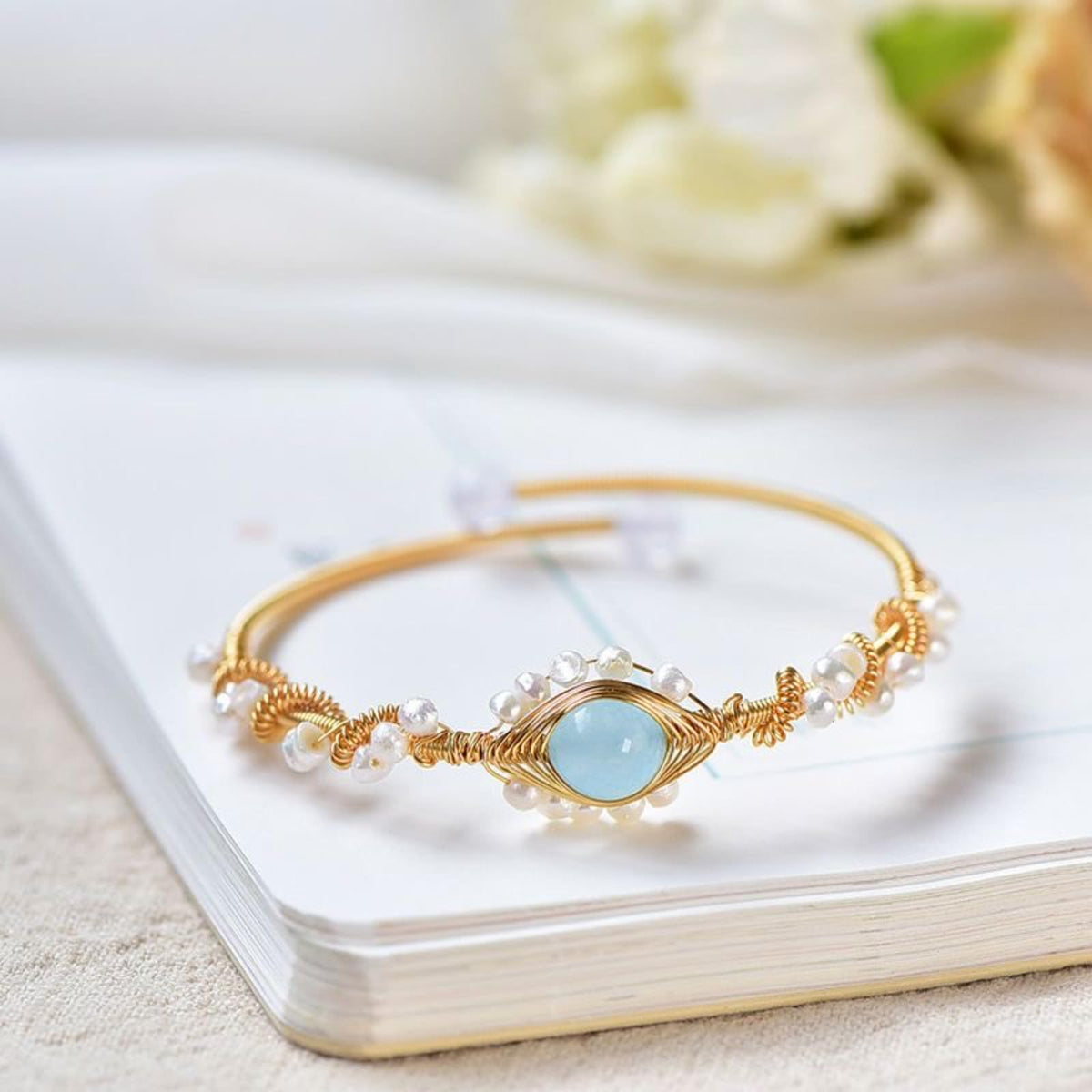 Pearl-wrapped gold cuff bracelet